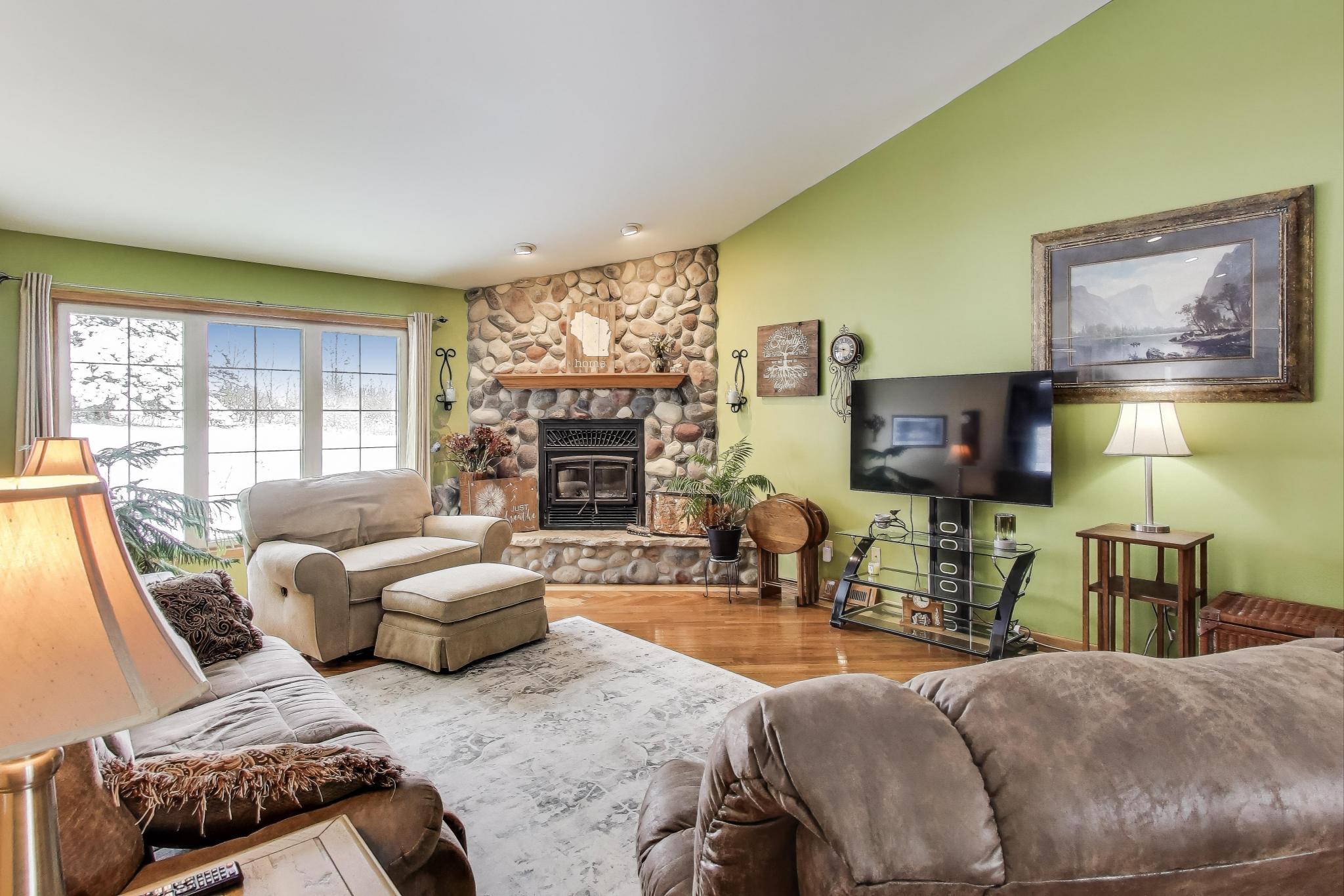 W312S8869 Cherokee Pass Mukwonago, WI 53149 - Photo 11 of 75 Living Room with large windows and natural fireplace.