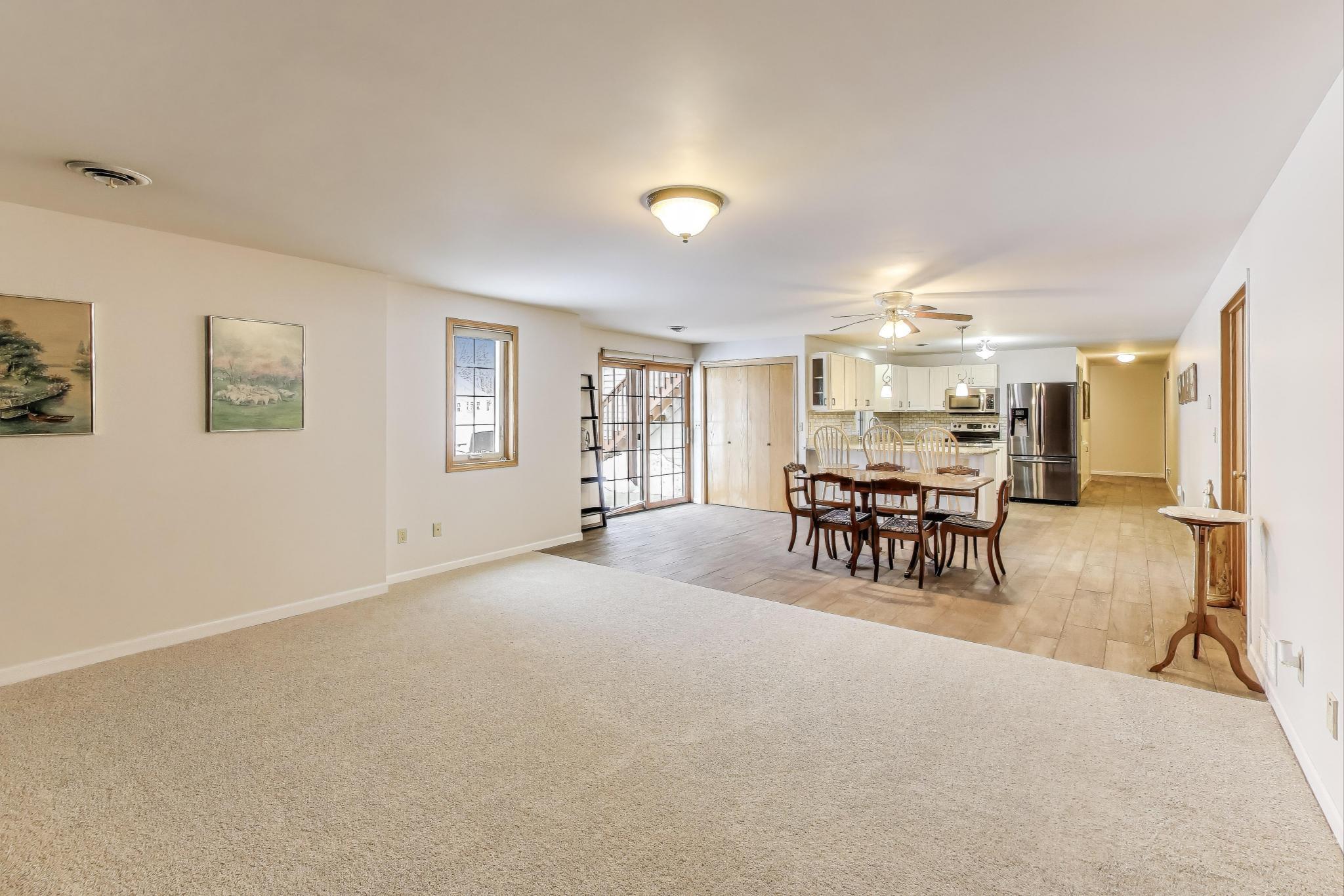 W312S8869 Cherokee Pass Mukwonago, WI 53149 - Photo 34 of 75 Family room on lower level with walk-out in dinette area. The door leads to the front patio.