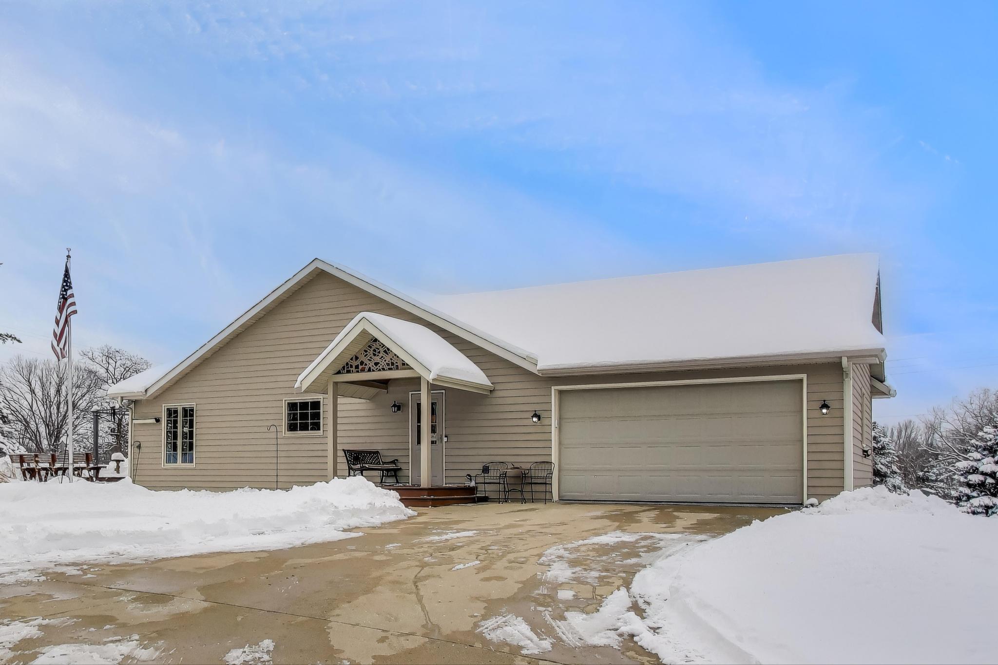 W312S8869 Cherokee Pass Mukwonago, WI 53149 - Photo 64 of 75 Side view with entry and main garage. Concrete driveway to main level garage.