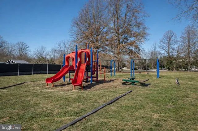 a view of dirt yard with a large tree
