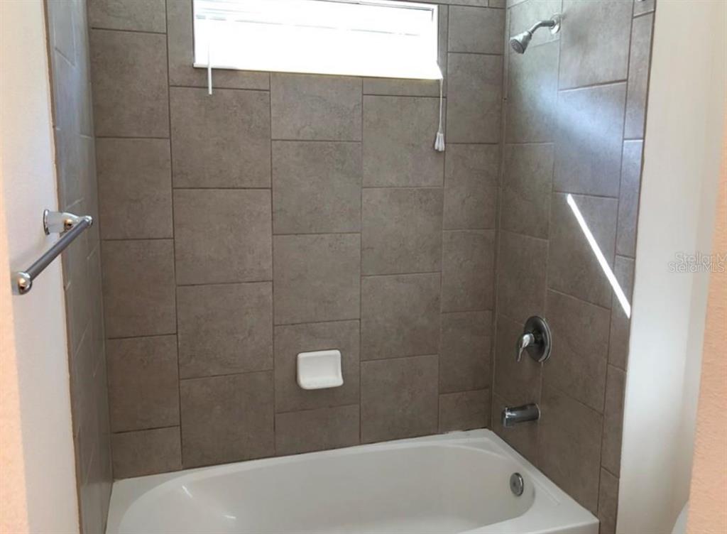 14903 Fells Lane Orlando, FL 32827 - Photo 11 of 14 a bathroom with a bathtub