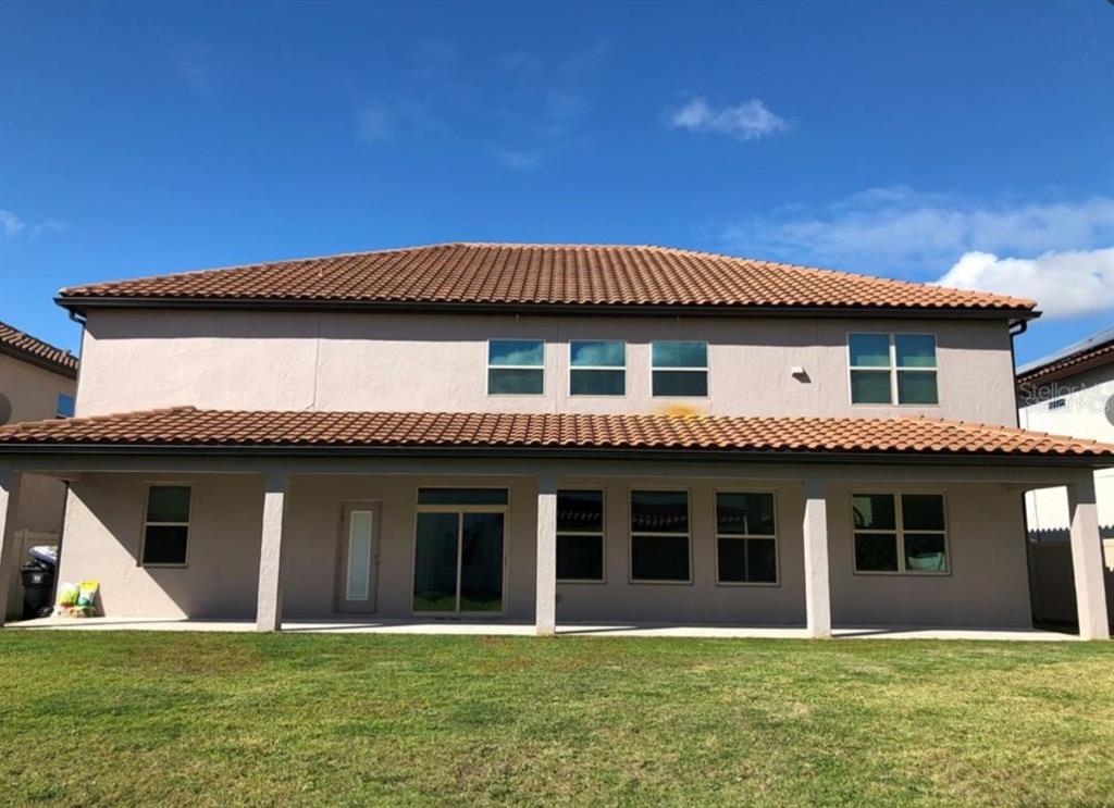 14903 Fells Lane Orlando, FL 32827 - Photo 14 of 14 a front view of a house with a yard
