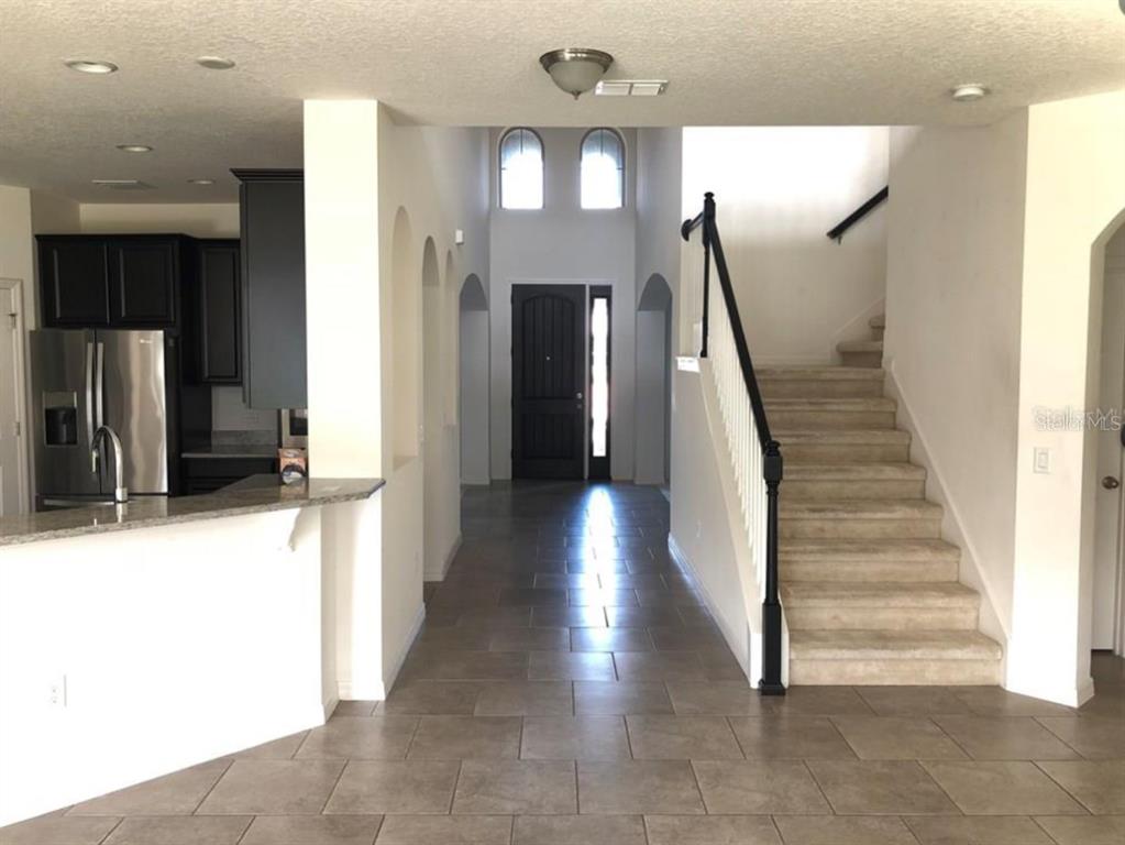 14903 Fells Lane Orlando, FL 32827 - Photo 6 of 14 a view of entryway and hall with wooden floor