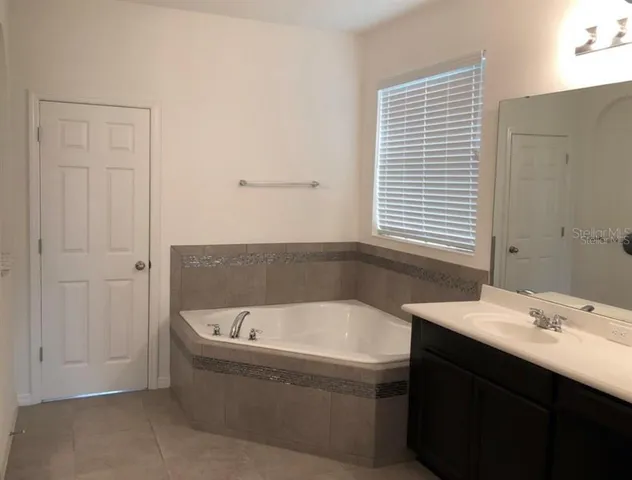 a bathroom with a bathtub and a sink