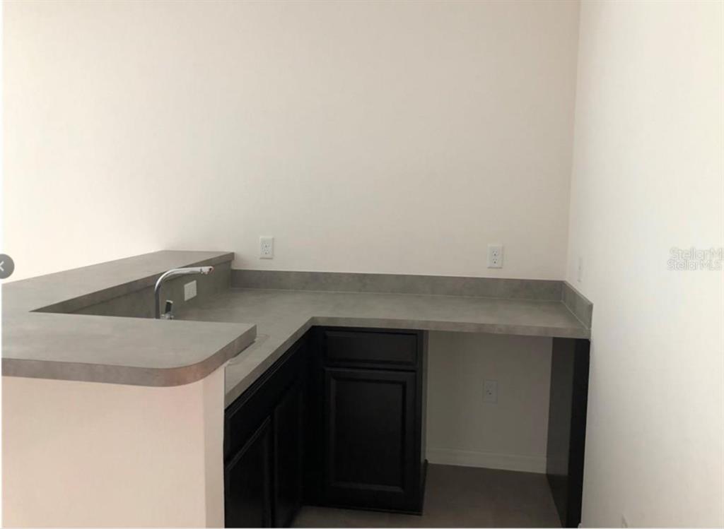 14903 Fells Lane Orlando, FL 32827 - Photo 10 of 14 a kitchen with a sink and cabinets