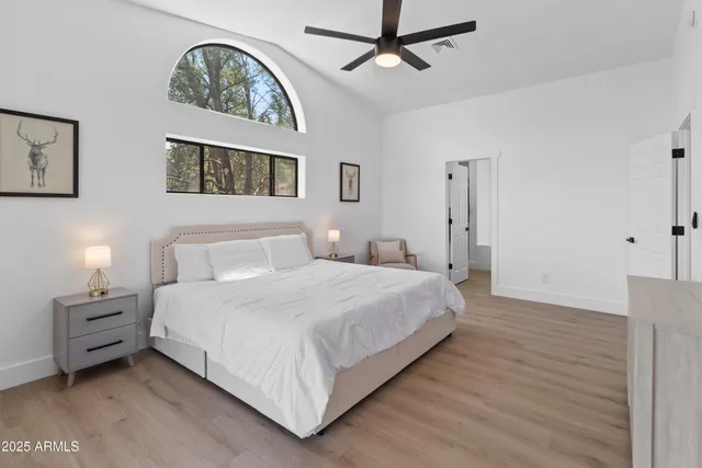 a bedroom with a bed and a chandelier