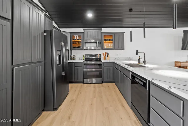 a kitchen with stainless steel appliances granite countertop a sink stove and refrigerator
