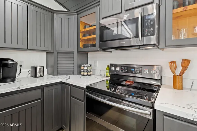 a kitchen with stainless steel appliances granite countertop a stove and a sink