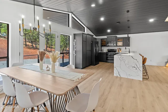 a kitchen with stainless steel appliances granite countertop a sink refrigerator and cabinets