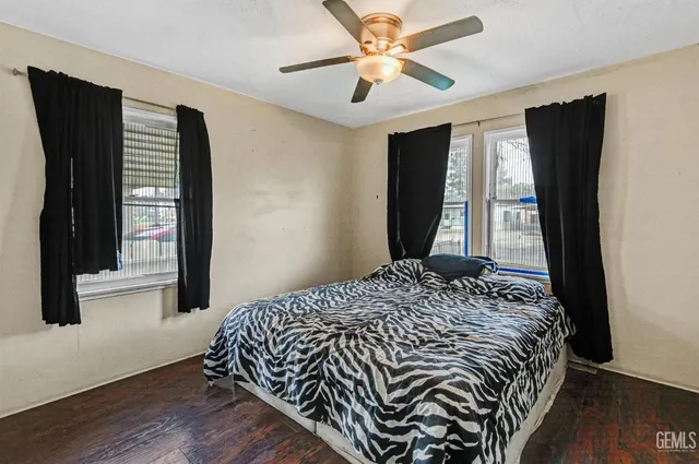 a bedroom with a bed and a large window