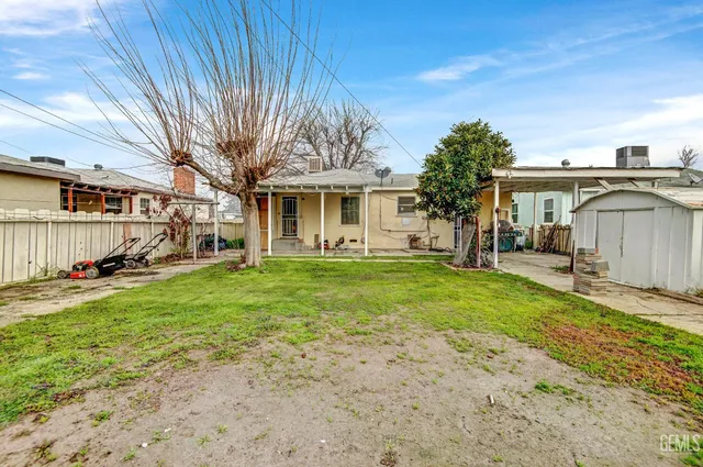 a front view of a house with a garden and yard
