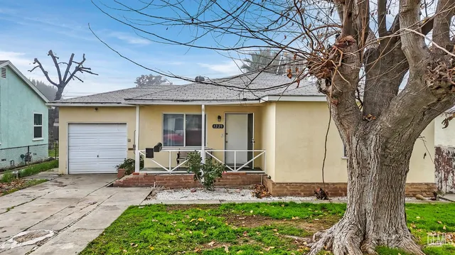a front view of a house with garden and porch
