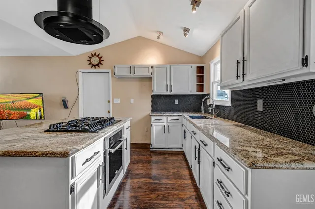 a kitchen with a stove and a sink