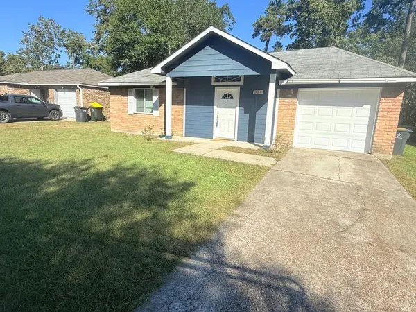 a view of a house with yard and a garden