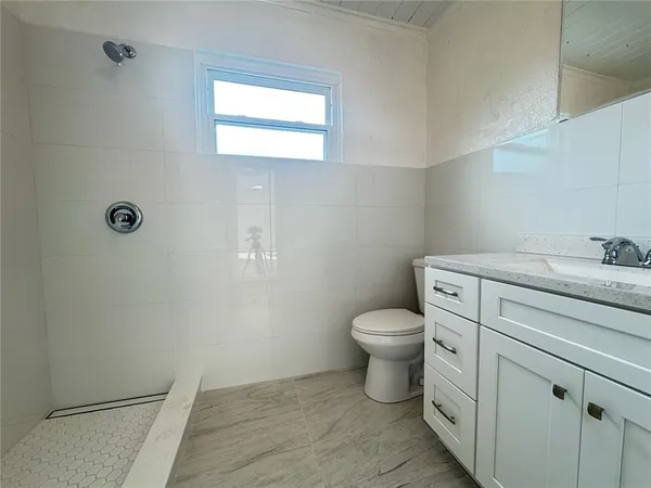 a bathroom with a toilet sink and vanity