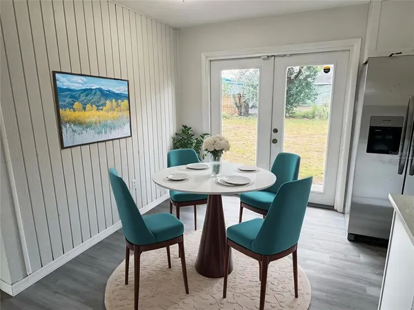 a view of a dining room with furniture window and wooden floor
