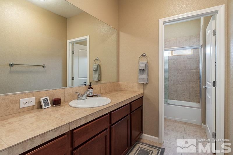 1640 Back Nine Trail Reno, NV 89523 - Photo 19 of 35 a bathroom with a granite countertop sink and a mirror