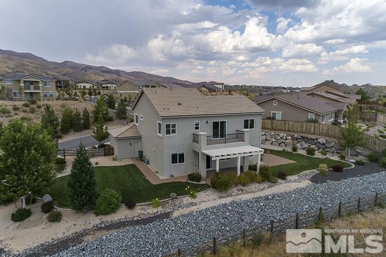 1640 Back Nine Trail Reno, NV 89523 - Photo 34 of 35 a view of a white house next to a yard with plants and large trees