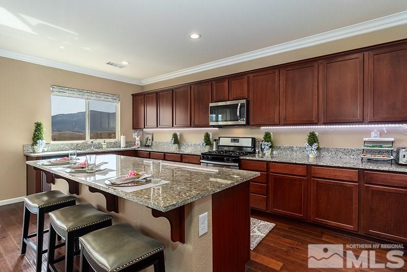 1640 Back Nine Trail Reno, NV 89523 - Photo 5 of 35 a kitchen with granite countertop a sink stove and cabinets