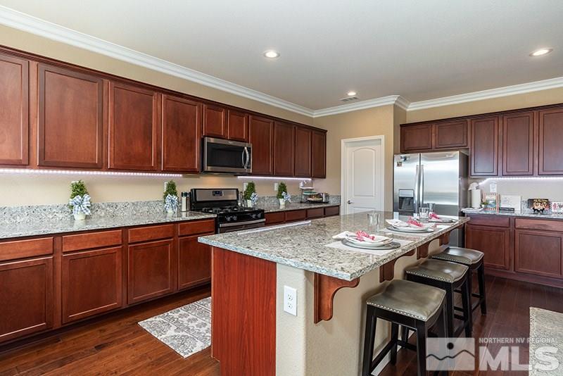 1640 Back Nine Trail Reno, NV 89523 - Photo 6 of 35 a kitchen with granite countertop sink stove top oven and microwave