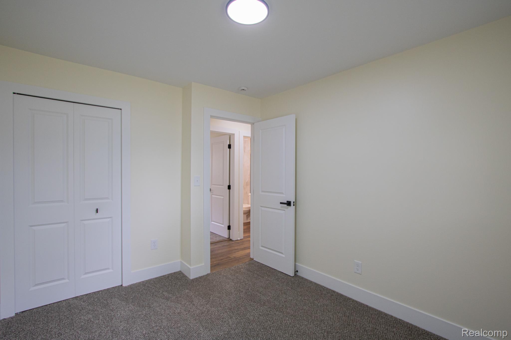 31000 Fall Fraser, MI 48026 - Photo 18 of 28 Unfurnished bedroom with dark colored carpet and a closet