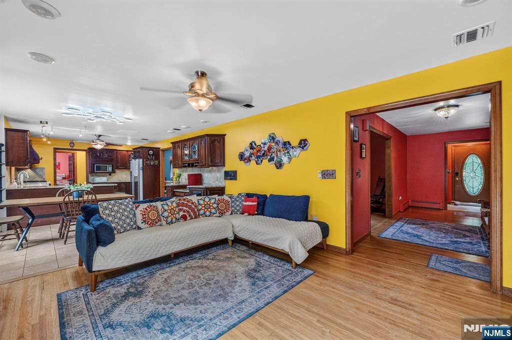 5110 Berkshire Valley Road Oak Ridge, NJ 07438 - Photo 12 of 49 a living room with furniture and wooden floor