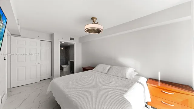 a bedroom with a bed and a lamp