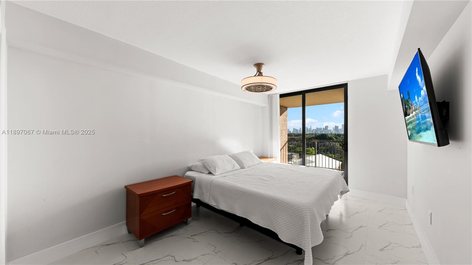 1690 Southwest 27th Avenue, Unit 603 Miami, FL 33145 - Photo 14 of 41 a bedroom with a bed and a painting on the wall