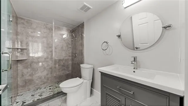 a bathroom with a sink toilet and shower