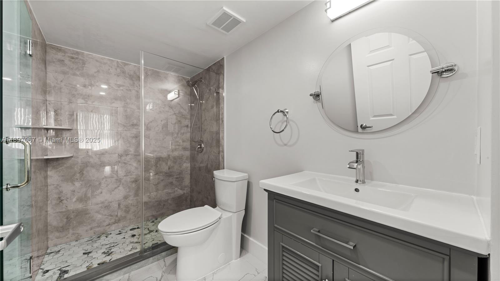 1690 Southwest 27th Avenue, Unit 603 Miami, FL 33145 - Photo 15 of 41 a bathroom with a sink toilet and shower