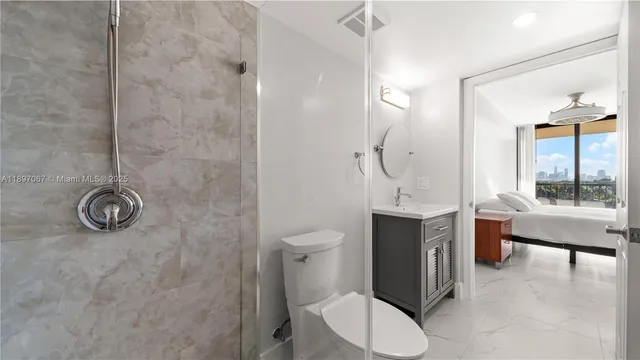 a bathroom with a toilet a sink and mirror