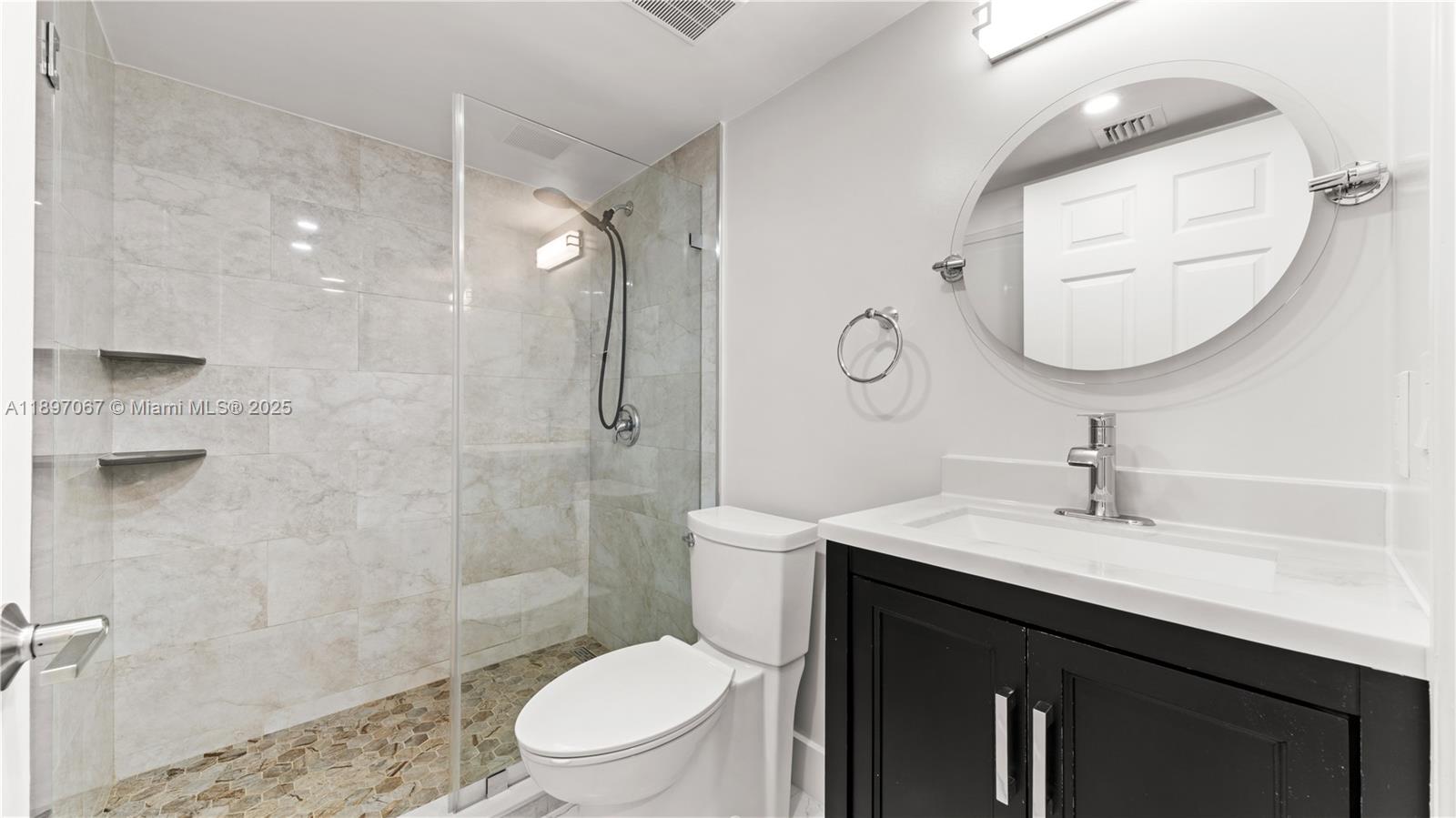 1690 Southwest 27th Avenue, Unit 603 Miami, FL 33145 - Photo 20 of 41 a bathroom with a sink a toilet and shower