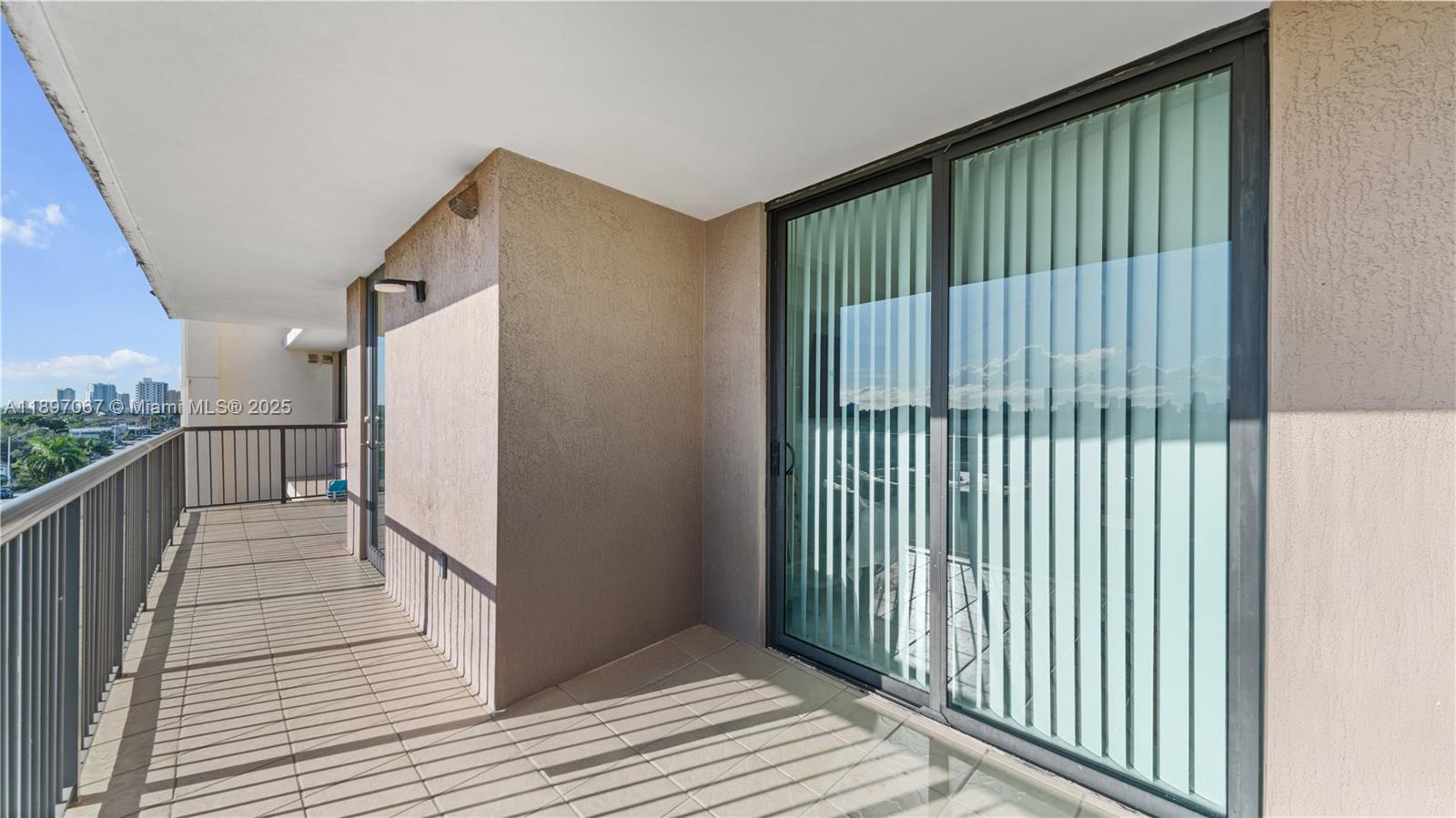 1690 Southwest 27th Avenue, Unit 603 Miami, FL 33145 - Photo 23 of 41 a view of a balcony with wooden floor