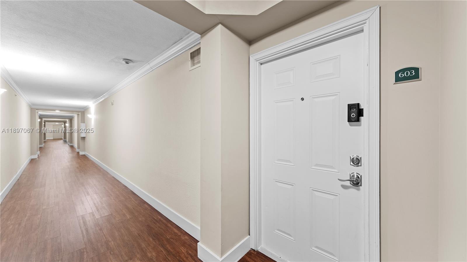 1690 Southwest 27th Avenue, Unit 603 Miami, FL 33145 - Photo 26 of 41 a view of a hallway with wooden floor