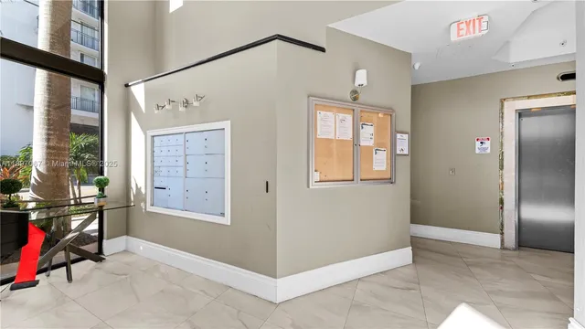 a view of a hallway with closet and wooden floor