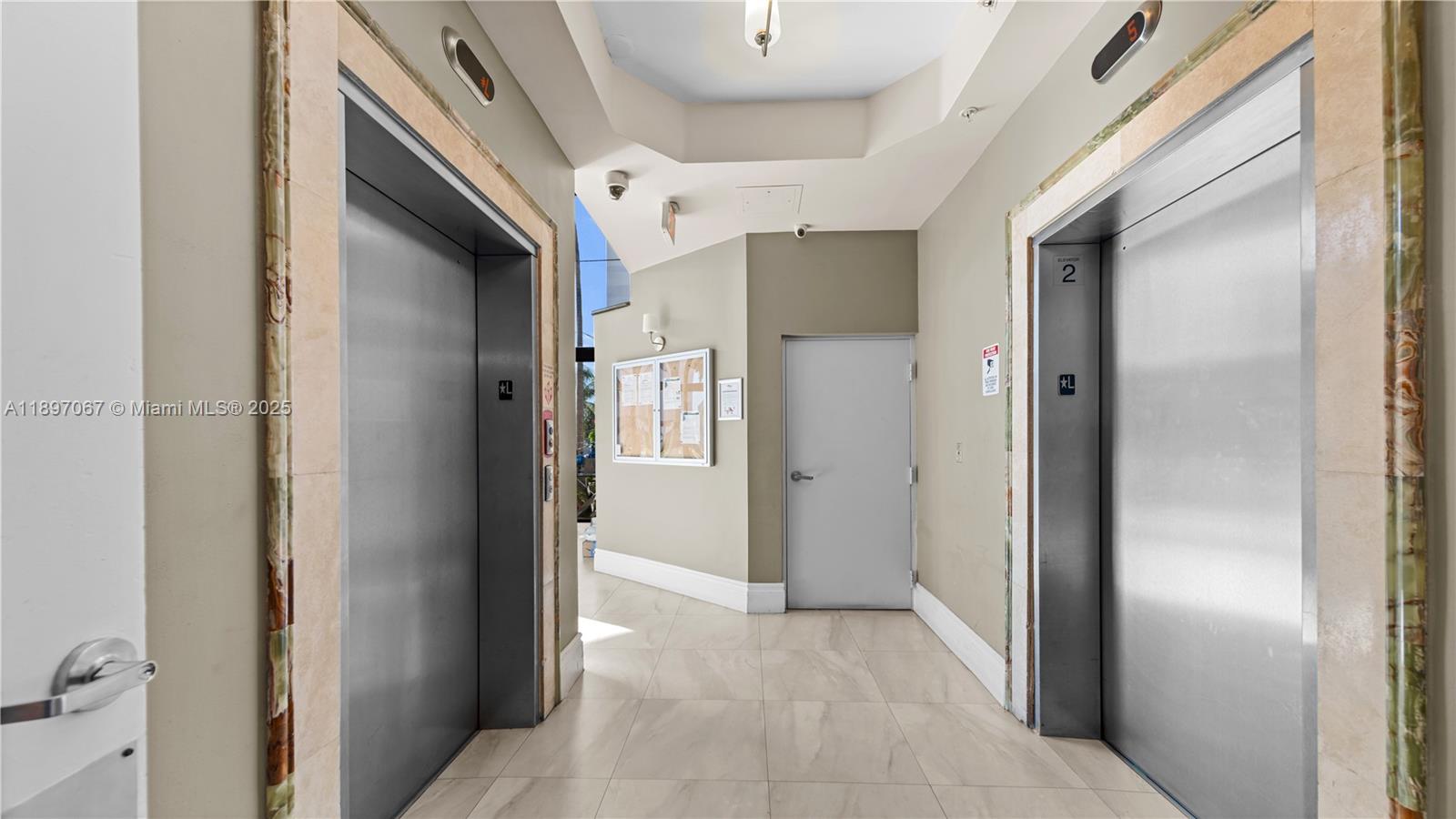 1690 Southwest 27th Avenue, Unit 603 Miami, FL 33145 - Photo 37 of 41 a view of a hallway with closet and wooden floor