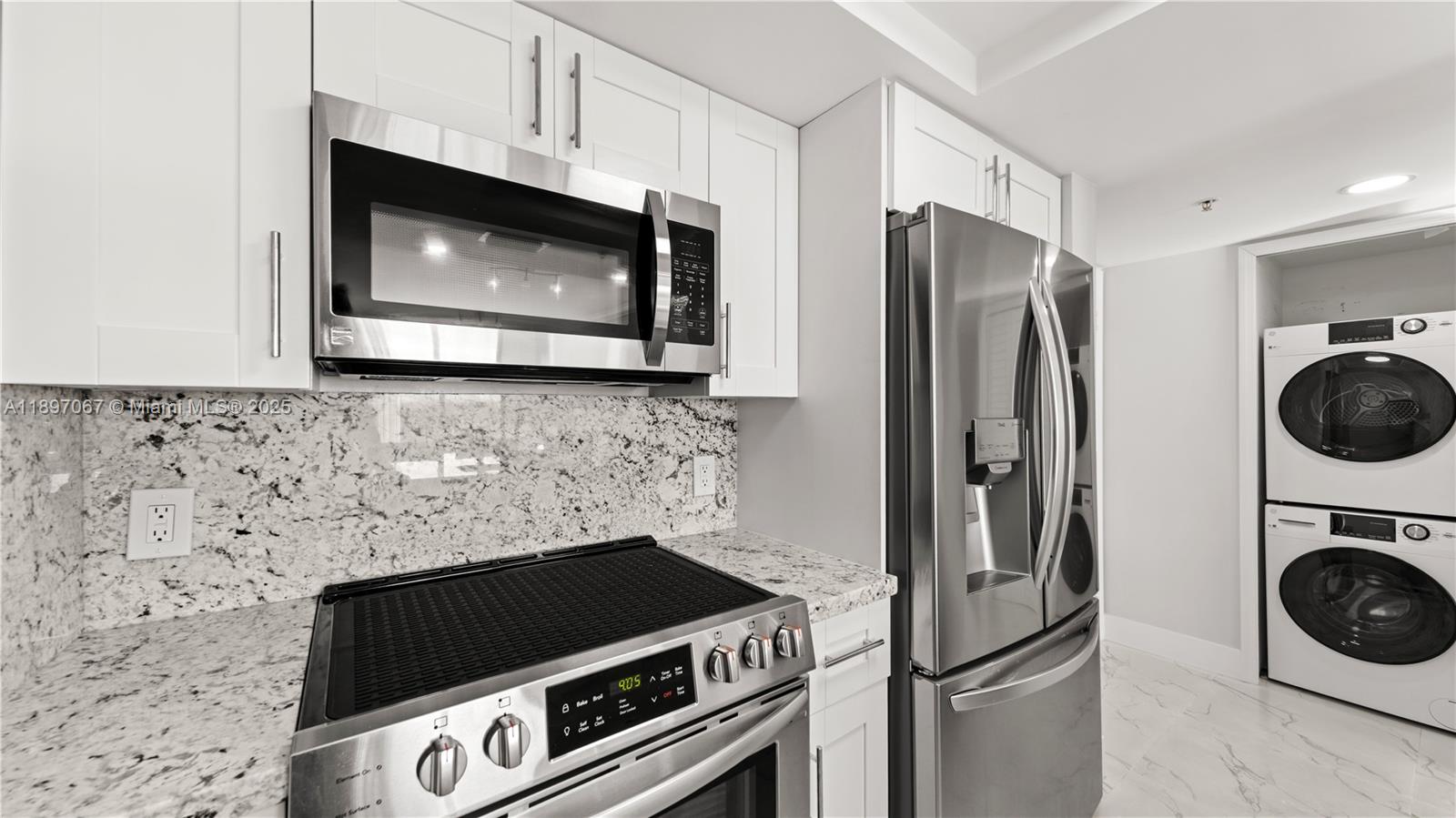 1690 Southwest 27th Avenue, Unit 603 Miami, FL 33145 - Photo 7 of 41 a kitchen with a stove and a microwave