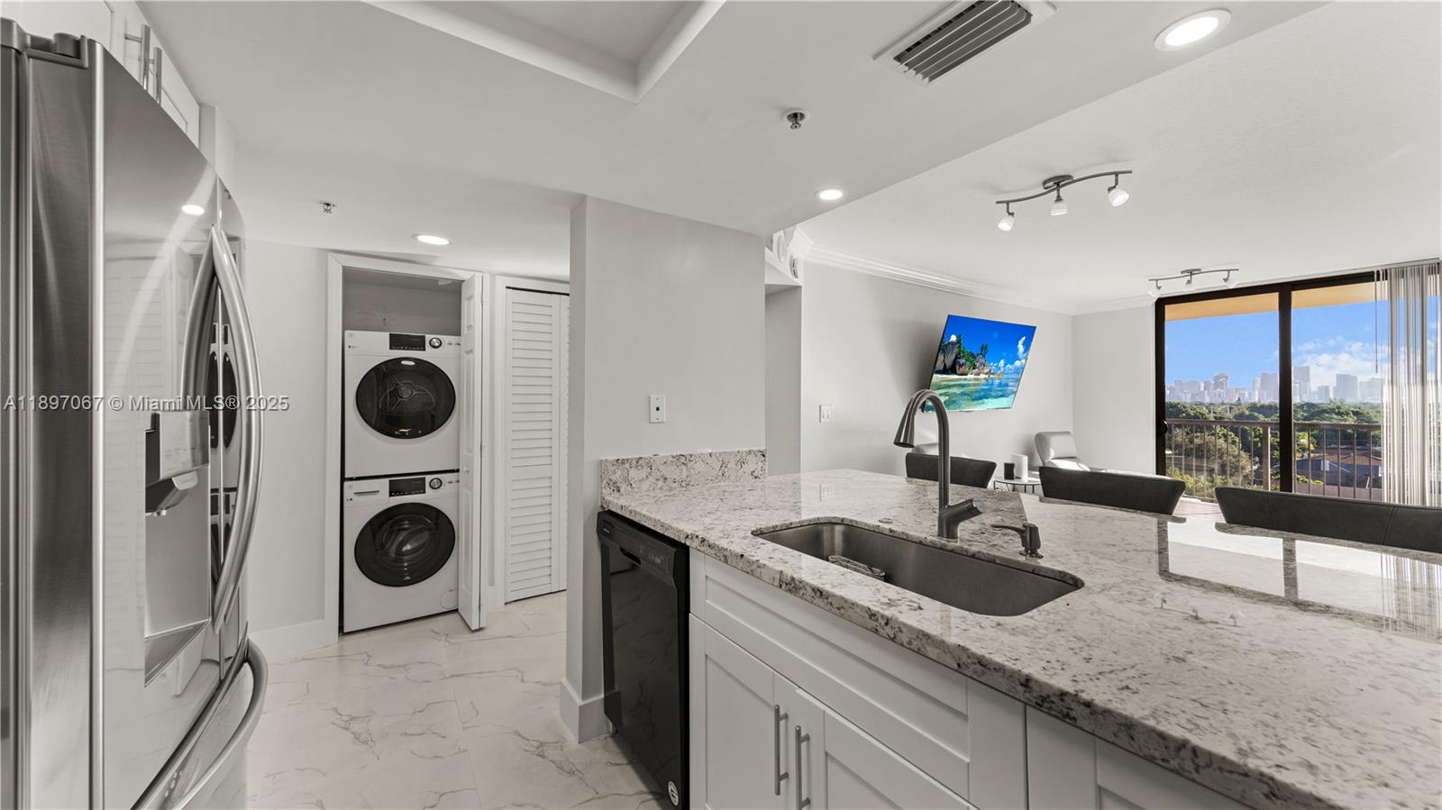 1690 Southwest 27th Avenue, Unit 603 Miami, FL 33145 - Photo 8 of 41 a view of a kitchen with a sink stainless steel appliances and cabinets