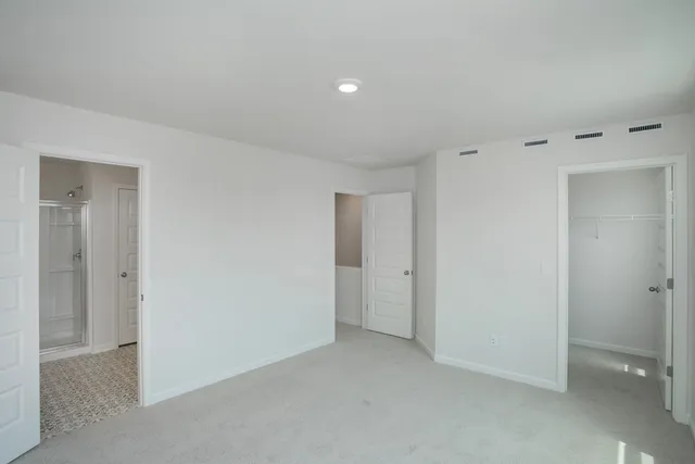 a view of an empty room and a window