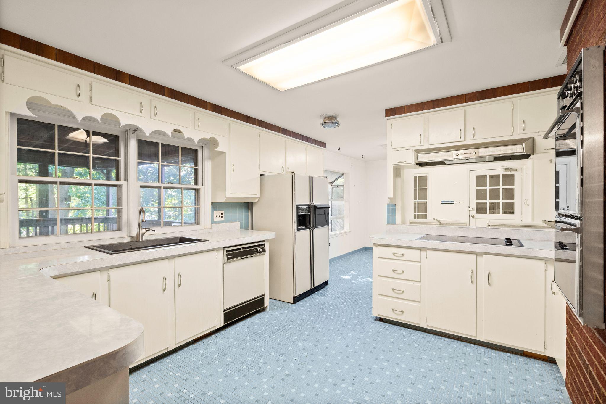 8311 Pohick Road Springfield, VA 22153 - Photo 22 of 92 a large white kitchen with stainless steel appliances granite countertop a stove and a sink
