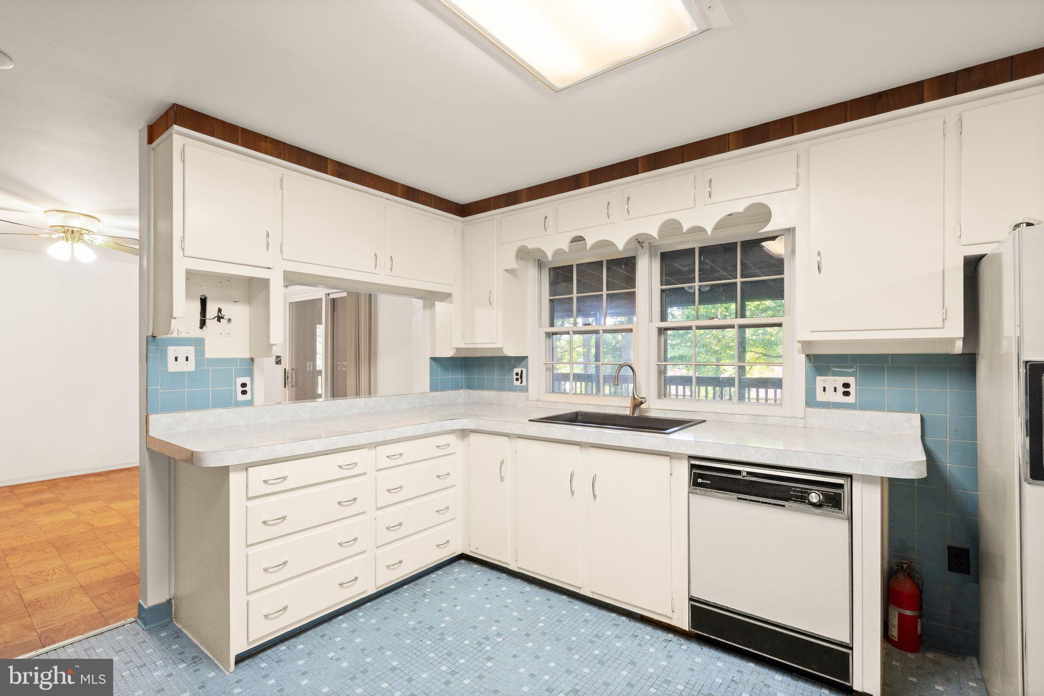 8311 Pohick Road Springfield, VA 22153 - Photo 23 of 92 a kitchen with granite countertop white cabinets and white appliances