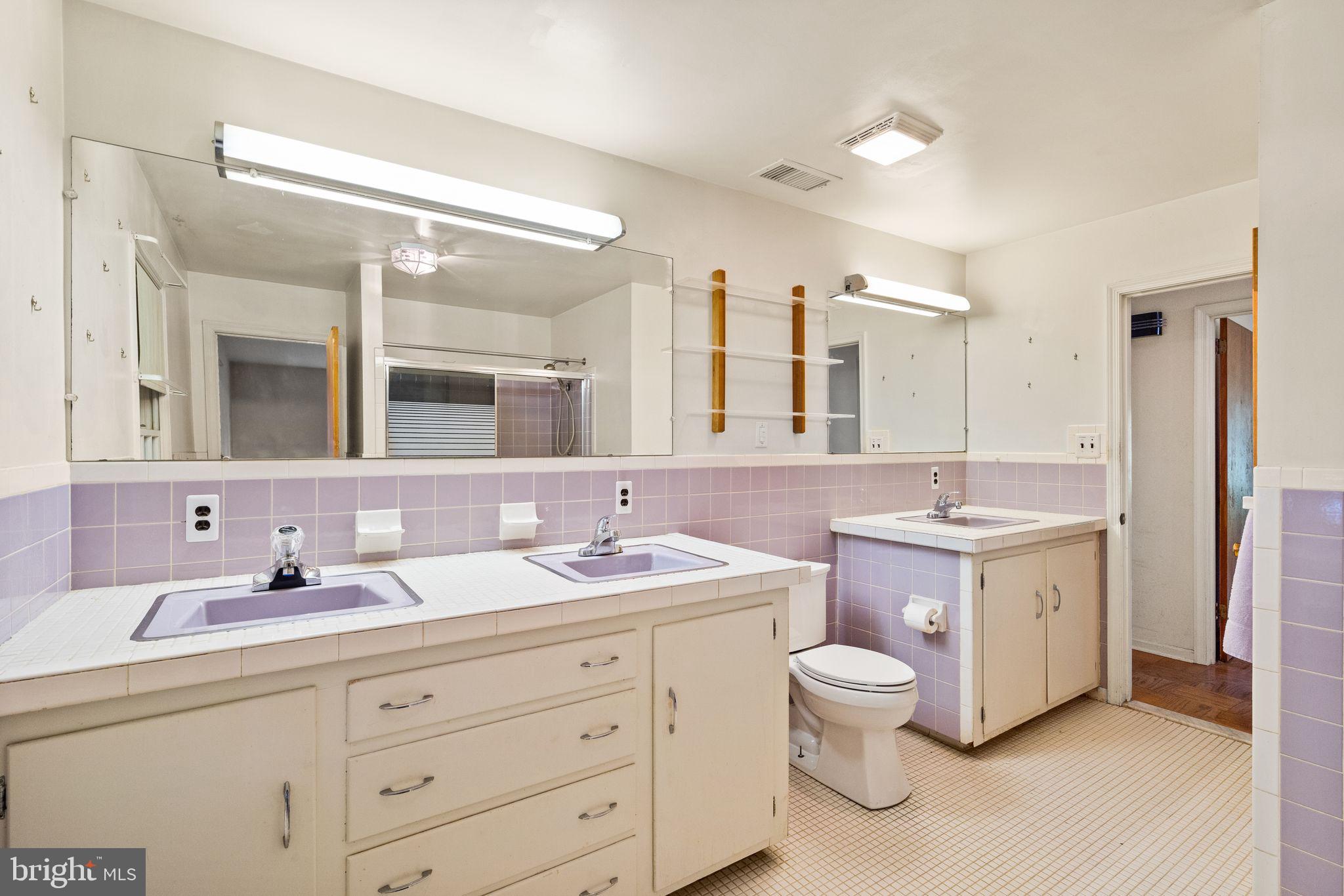 8311 Pohick Road Springfield, VA 22153 - Photo 43 of 92 a bathroom with a double vanity sink mirror double and toilet