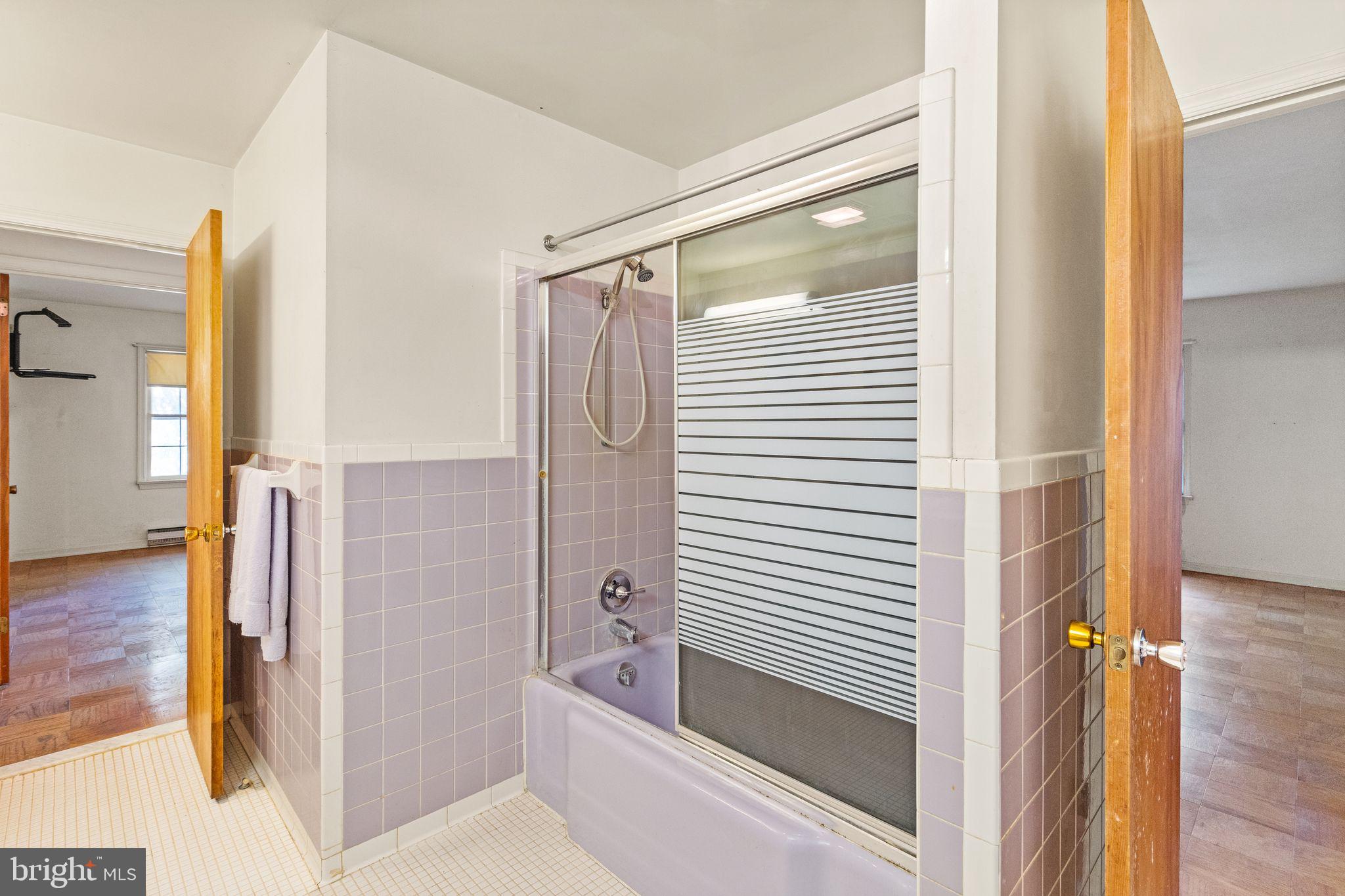 8311 Pohick Road Springfield, VA 22153 - Photo 45 of 92 a bathroom with a tub and shower