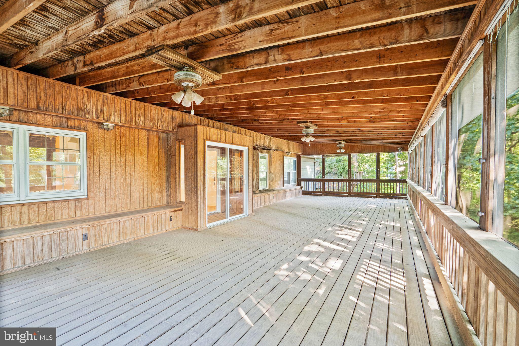 8311 Pohick Road Springfield, VA 22153 - Photo 46 of 92 a view of an empty room with wooden floor and a window