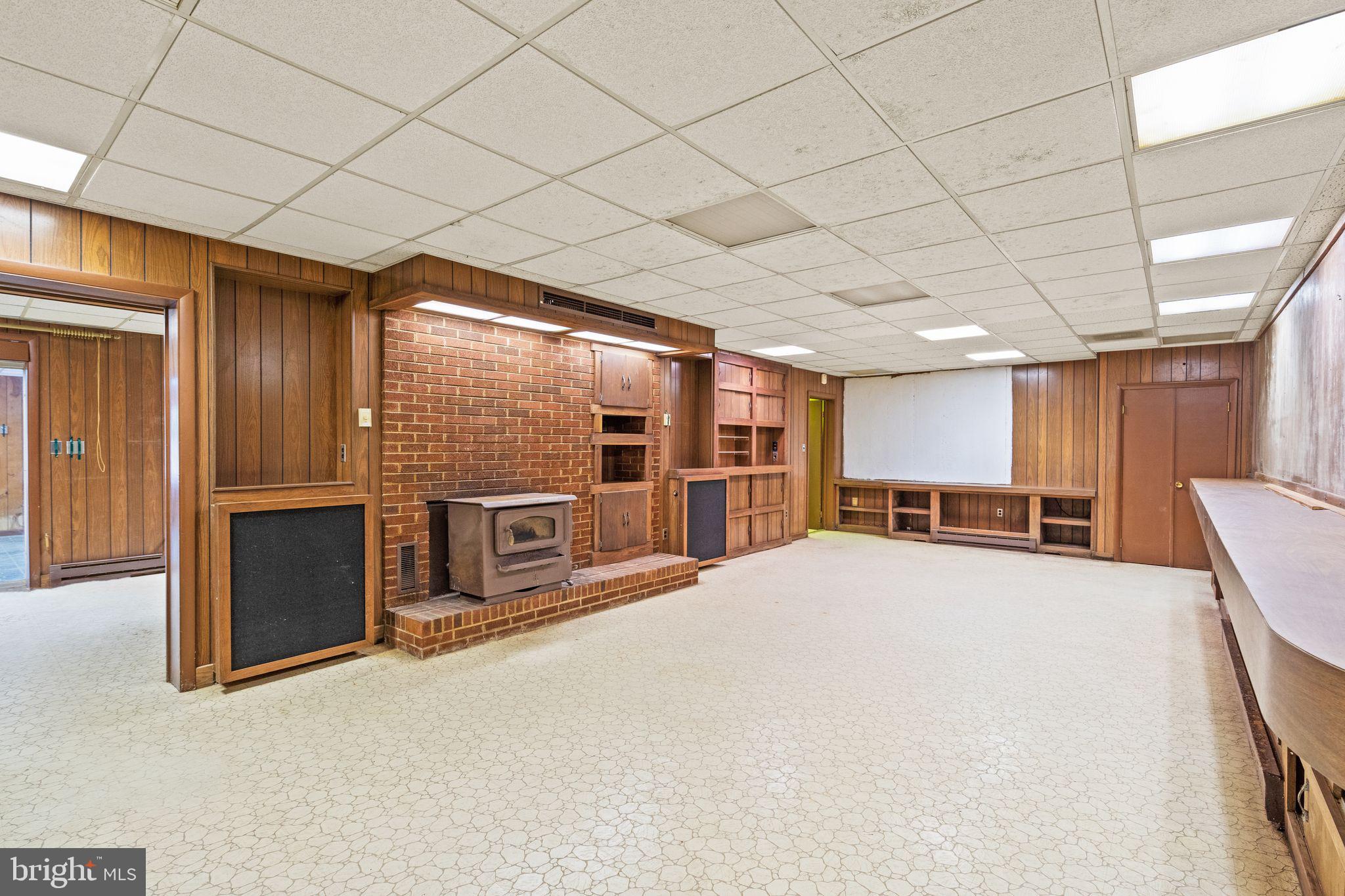 8311 Pohick Road Springfield, VA 22153 - Photo 54 of 92 a large room with a large window and a kitchen counter space