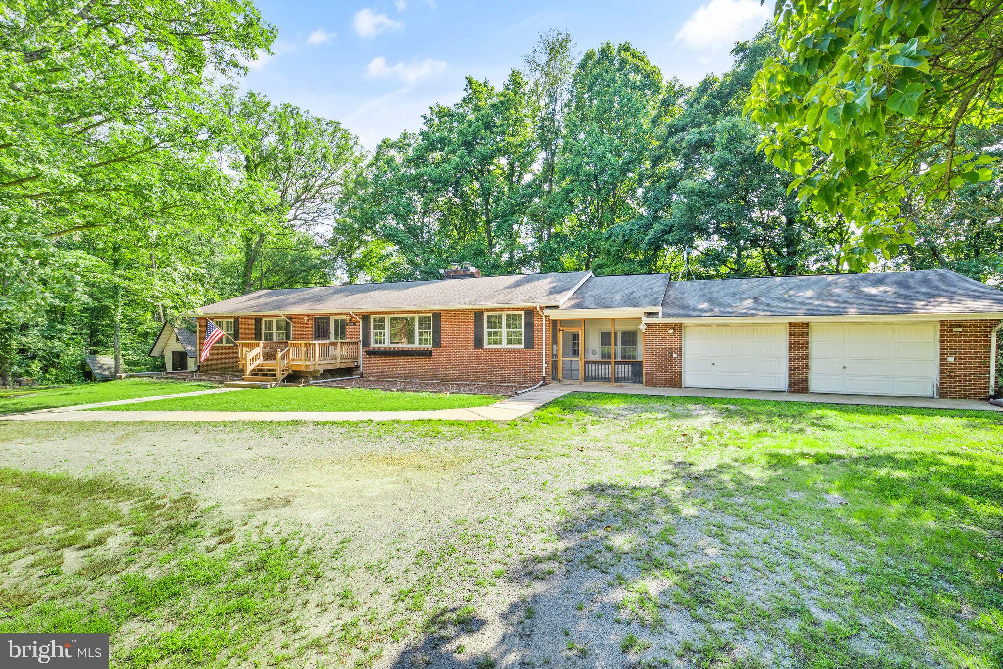 8311 Pohick Road Springfield, VA 22153 - Photo 6 of 92 a front view of a house with a garden