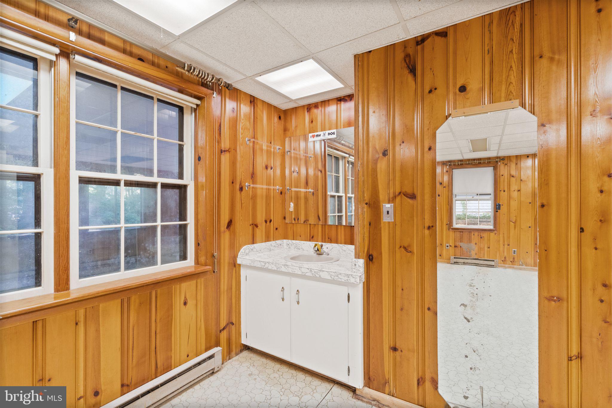 8311 Pohick Road Springfield, VA 22153 - Photo 65 of 92 a view of a bathroom with a sink and a mirror