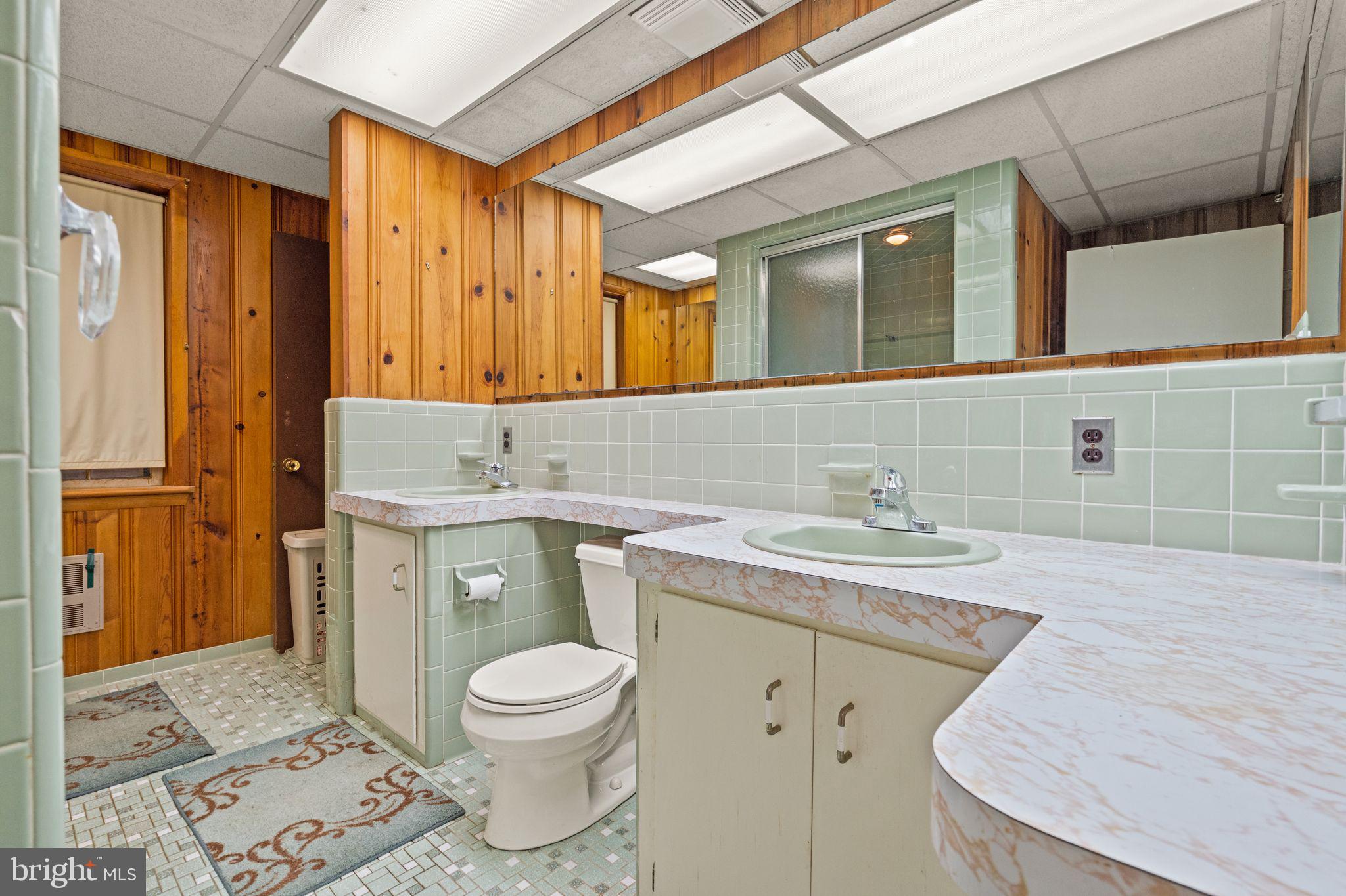 8311 Pohick Road Springfield, VA 22153 - Photo 67 of 92 a bathroom with a granite countertop toilet sink and mirror