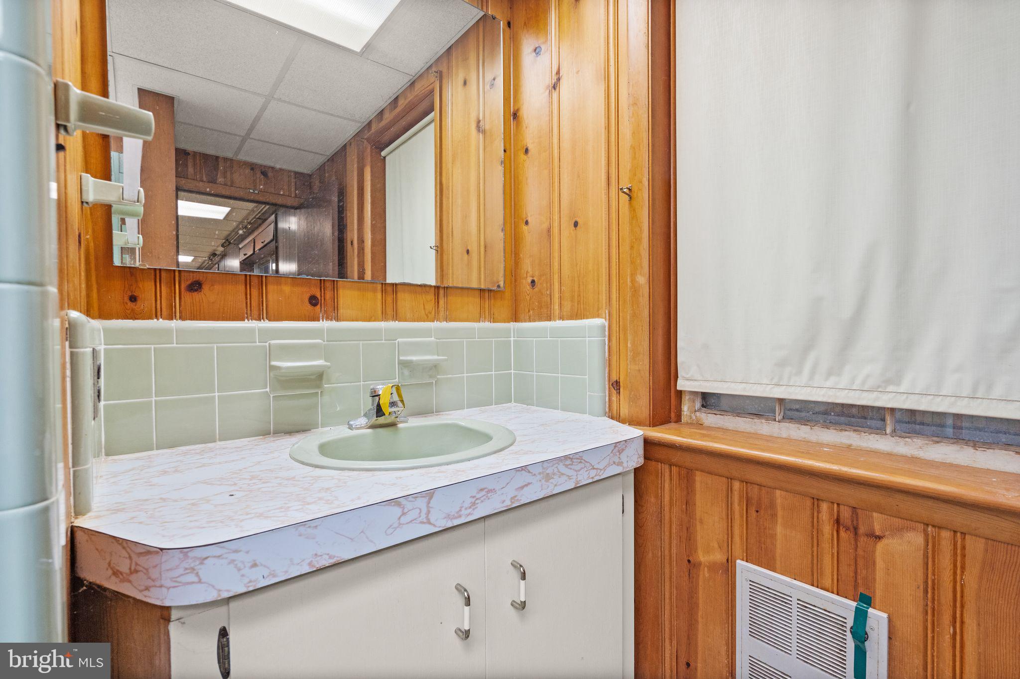 8311 Pohick Road Springfield, VA 22153 - Photo 69 of 92 a bathroom with a sink and a mirror