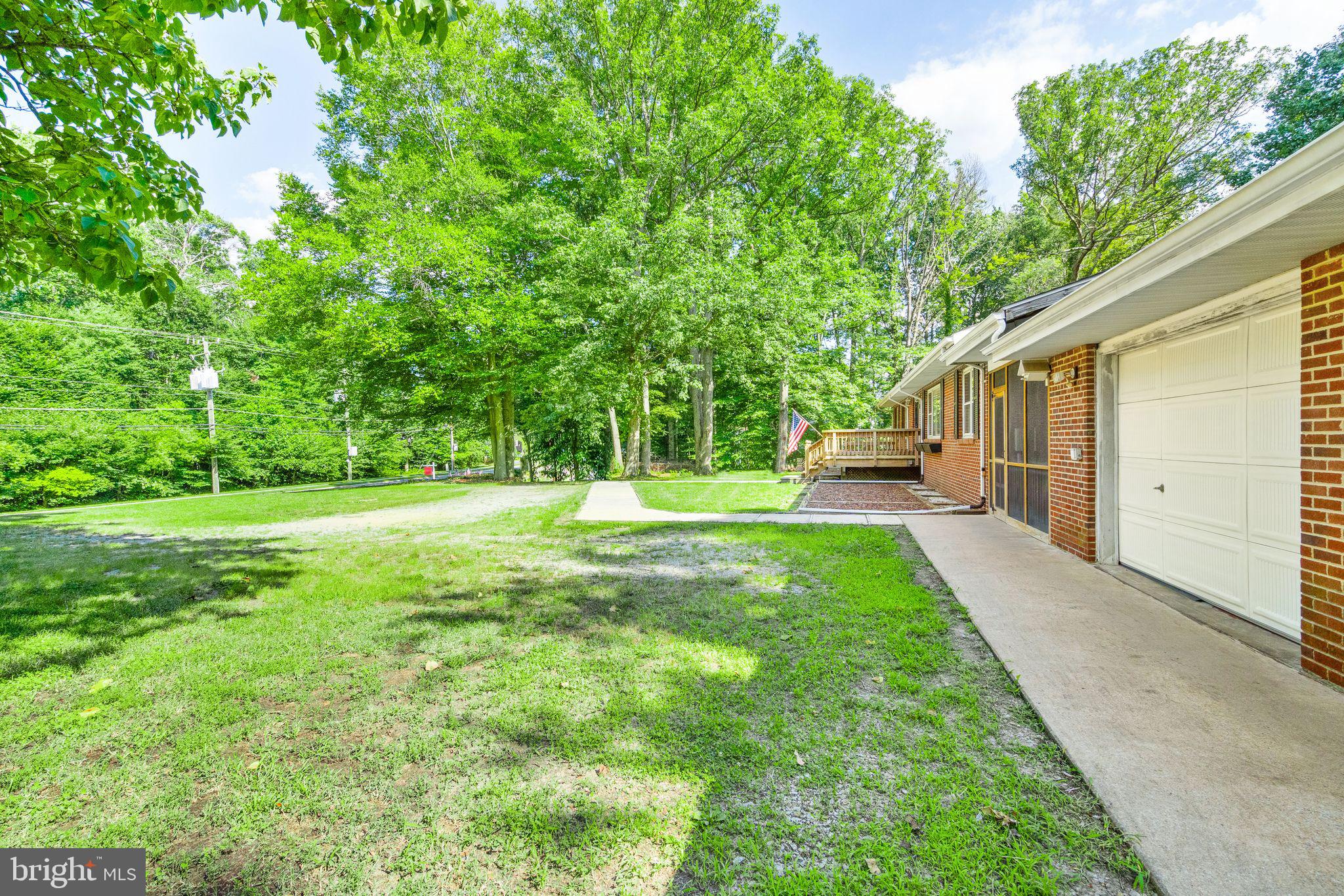 8311 Pohick Road Springfield, VA 22153 - Photo 10 of 92 a view of a house with backyard and trees